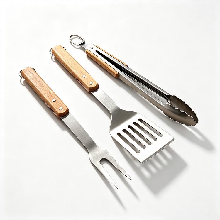 Premium Stainless Steel BBQ Tool Set with Wooden Handles - Includes Fork, Shovel, and Tongs for Outdoor Camping and Grilling.