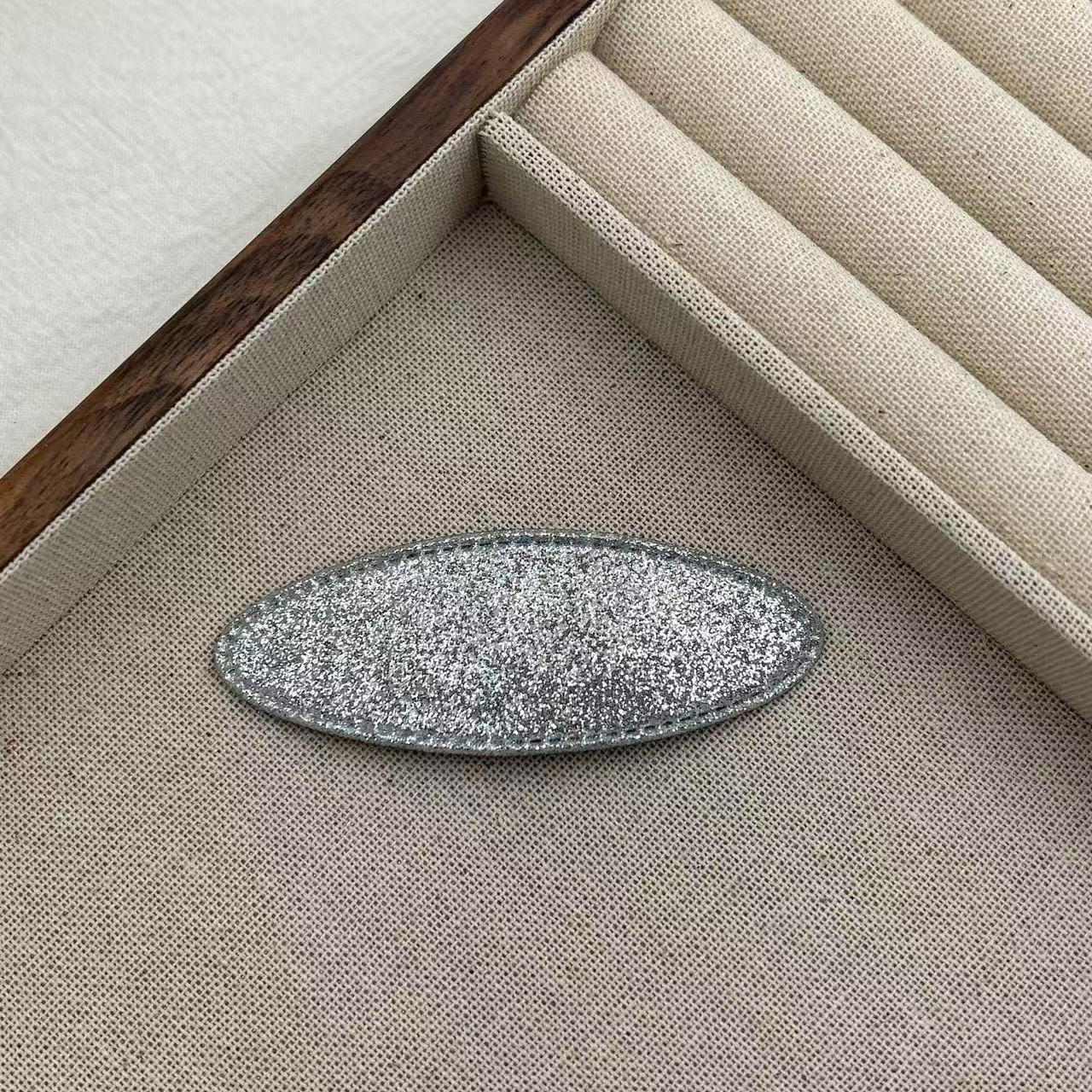 

Korean Silver Glitter Oval Hair Clip for Women - Stylish Side Clip for Bangs