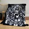 A skull-heavy design with a "rock on" hand gesture, guitars, and dark motifs. for all seasons blanket lunch break throw gift