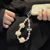 New high-end autumn and winter pom-pom mobile phone chain beaded short lanyard bag keychain pendant girl pendant