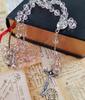 Light pink crystal bead rosary Catholic necklace with sacred earth medal and cross.