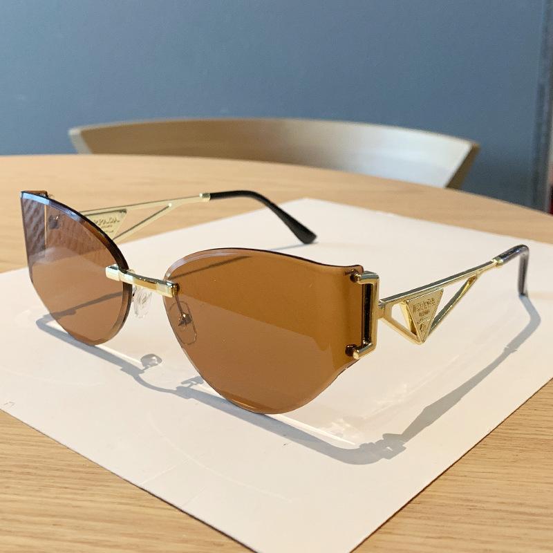 European and American new street photography frameless sunglasses women's hollow metal frames advanced cat glasses sunscreen sunglasses