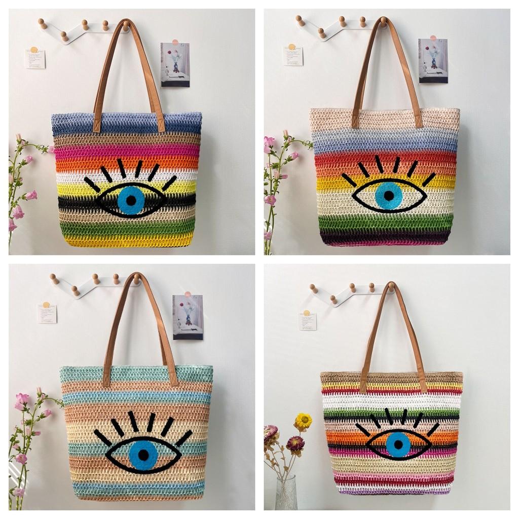 Große geflochtene Raffia-Strandtasche mit Augen-Print-Design und zwei Schultergurten für den Urlaub