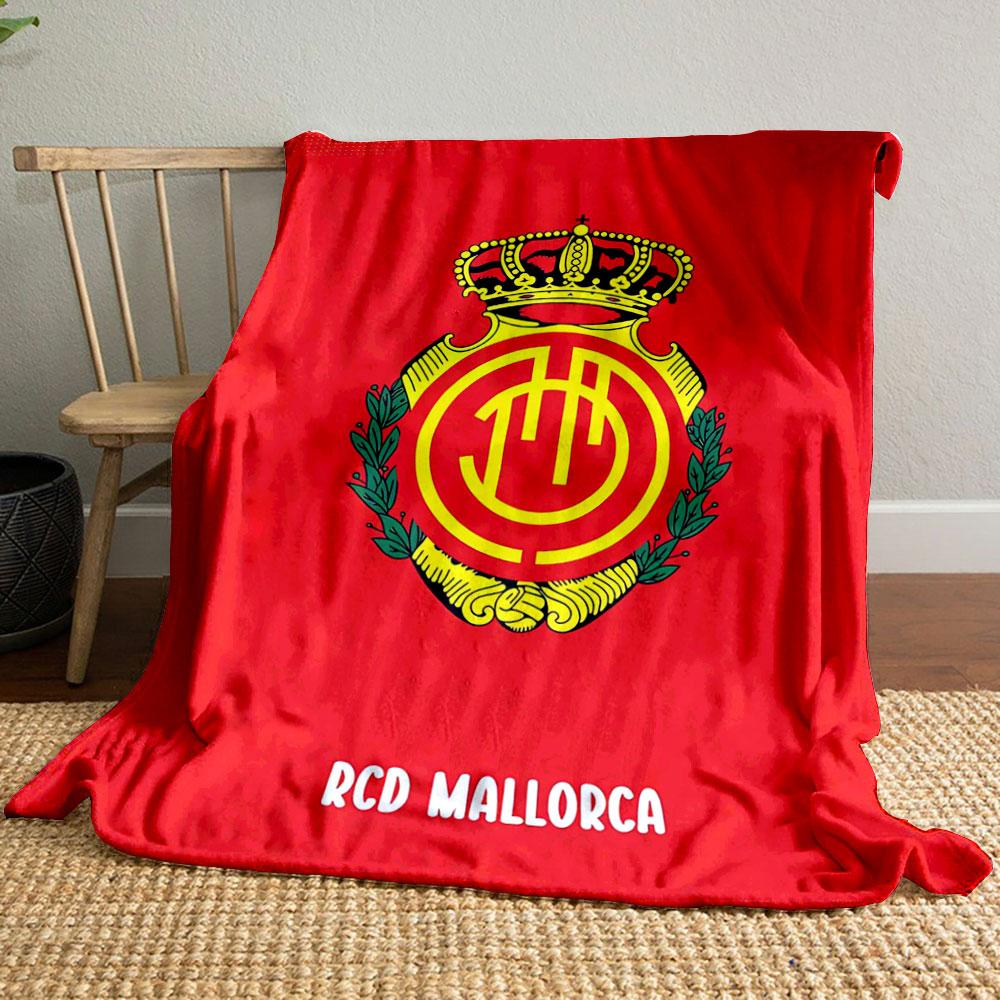 A crowned emblem with yellow circular patterns on a red background. for all seasons blanket lunch break throw gift