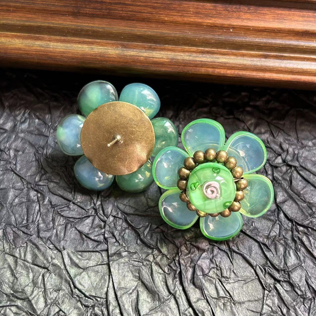 

A multi-layered glass rose necklace and earrings in a vintage court style, luxurious jewelry.