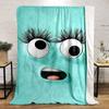 A playful turquoise face with large eyes, long lashes, and an open mouth. for all seasons blanket lunch break throw gift