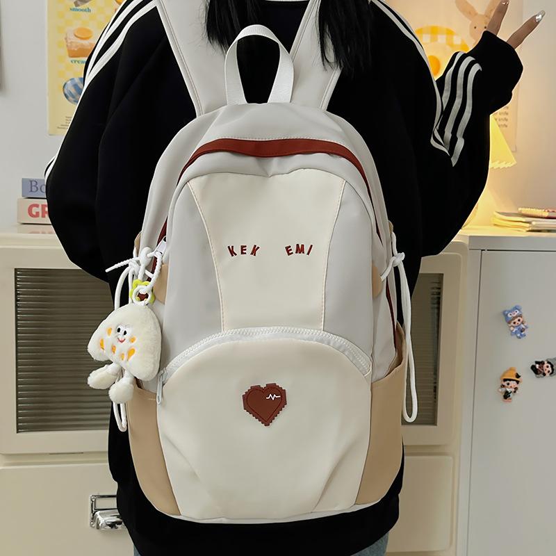 Exquisite and cute color matching large-capacity load reduction male and female student schoolbags 25 new casual size backpacks