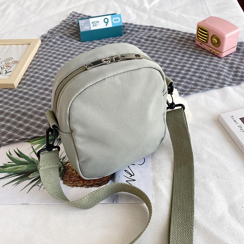 Piccola borsa a tracolla da donna in tela con tasca per cellulare e design a blocchi di colore, ideale per l'uso quotidiano.