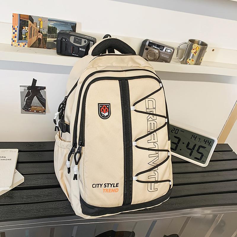 High-value retro tooling trendy and cool backpack for junior high school students, casual, simple, lightweight and large-capacity backpack.