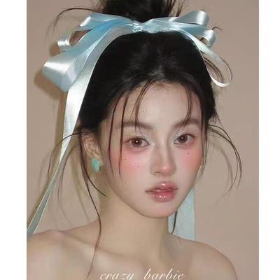 Girlish Charm: Blue Ribbon Hair Clip for Bridal Updos