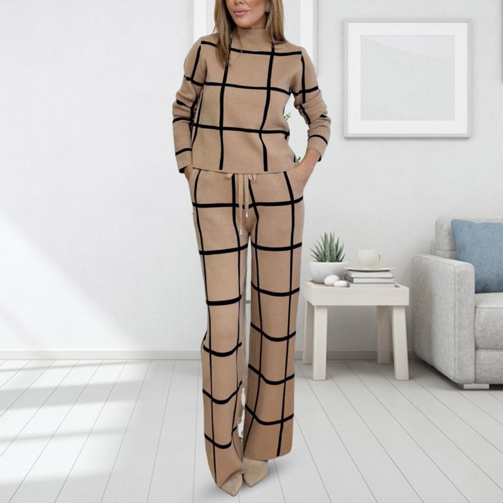 Set aus langärmligem Oberteil und Hose mit weitem Bein. Eleganter Anzug mit Karomuster und Hose mit weitem Bein. Lockere Bluse für Damen. Stilvolle Bürokleidung