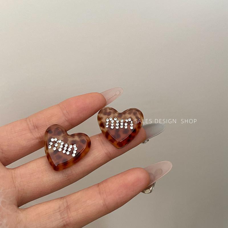 

Korean Rhinestone Leopard Print Heart Stud Earrings: High-End Fashion for Women.