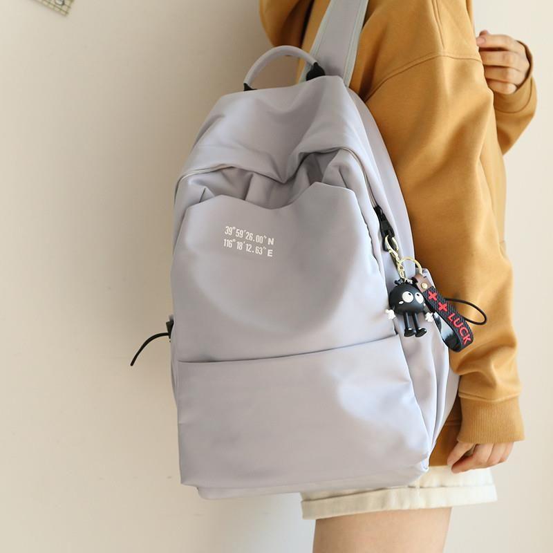 

JK Large Capacity Backpack Women s Backpack Men s Schoolbag Junior High School Girls College Students Lightweight Travel Backpack Light gray + long-legged black briquettes