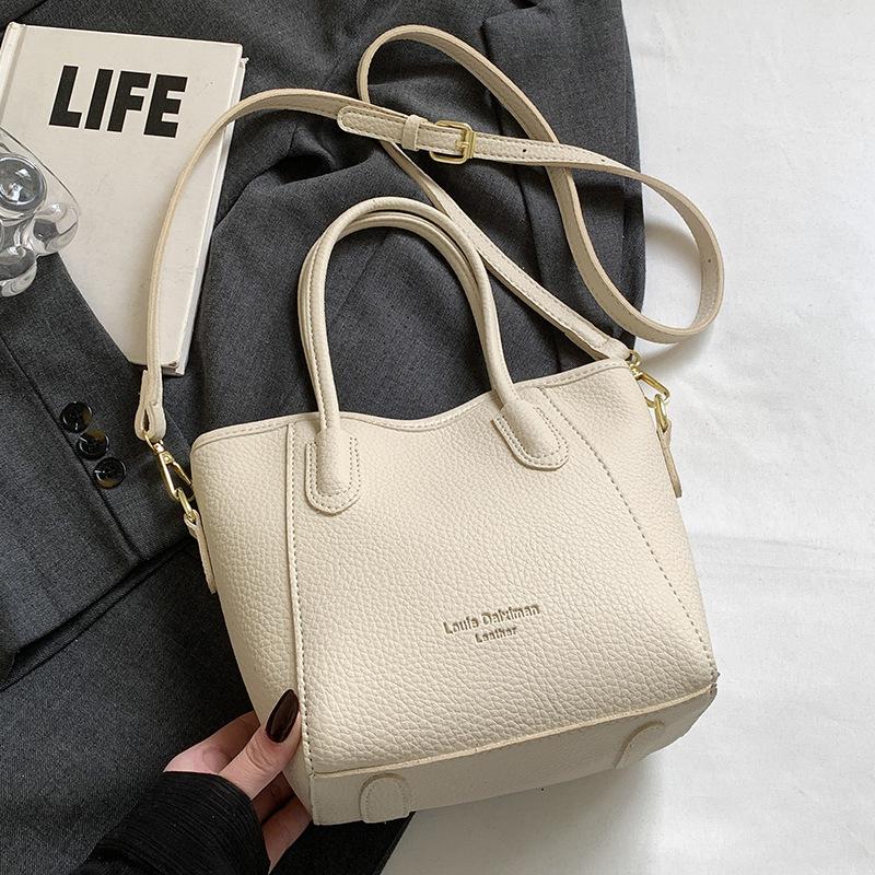 Stylish and Simple Style Lychee Pattern Texture Portable Bucket Bag Korean Version Casual Commuting Versatile Solid Color Messenger Women's Bag