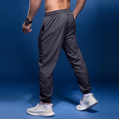 Letní úzké prodyšné běžecké fitness kalhoty kapsa na zip jednobarevné pánské fotbalové tréninkové pouto rychleschnoucí ležérní kalhoty trendy tepláky