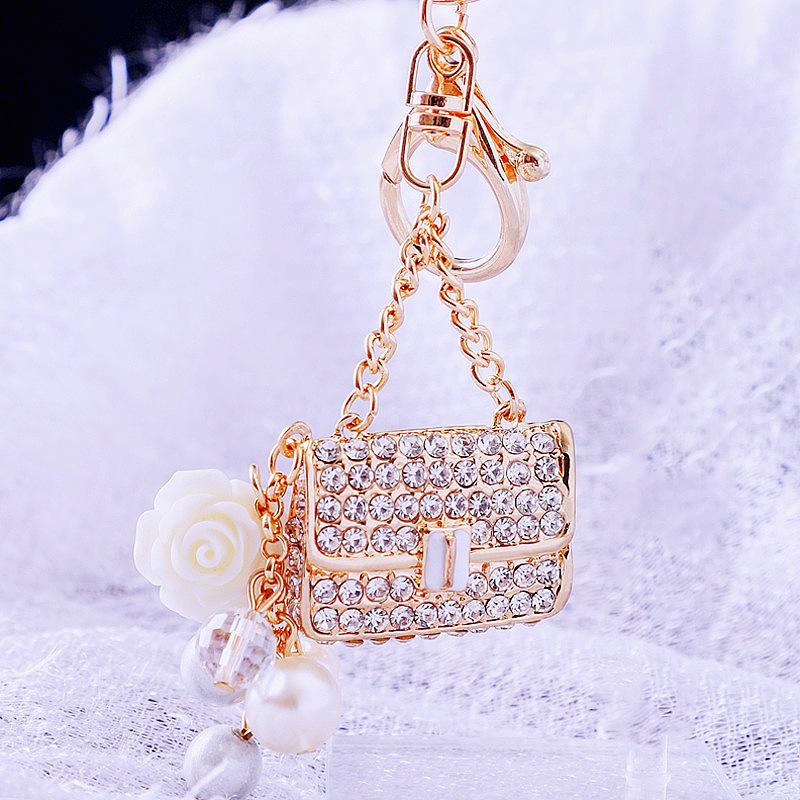 

Pearl scented small shoulder bag, car keychain, women s bag pendant, metal keychain ring, diamond inlaid small gift Single opp bag packaging