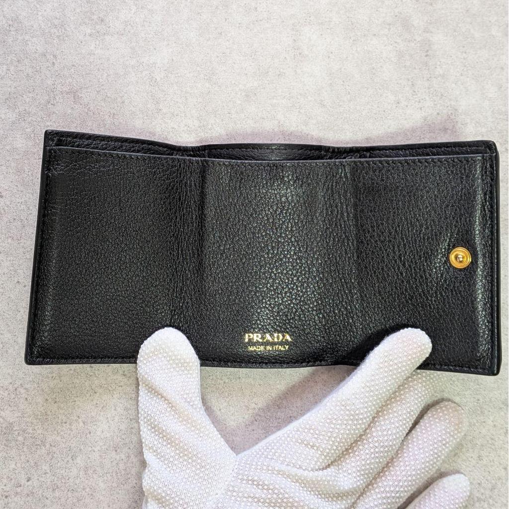 Used Beautiful condition  Prada trifold wallet, letter shape, metal logo, Vitello Daino, compact