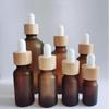 Brown Glass Essential Oil Bottle with Bamboo Lid and Dropper for Cosmetics