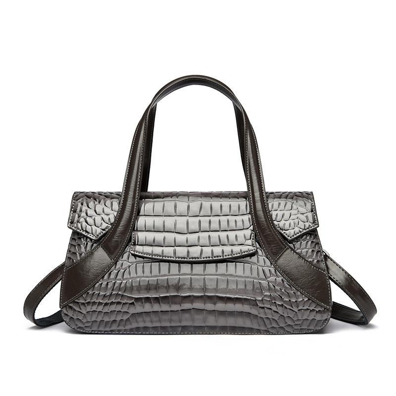 Diese Handtasche ist eine Damenhandtasche mit großem Fassungsvermögen und Krokodilmuster.. Es kann in der Hand, über der Schulter oder als Umhängetasche getragen werden.