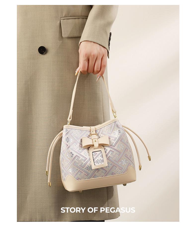 Guangxi Zhuang Brocade Heritage Women's Bow Drawstring Bag - 2026 New Chinese Style Crossbody Bucket Bag
