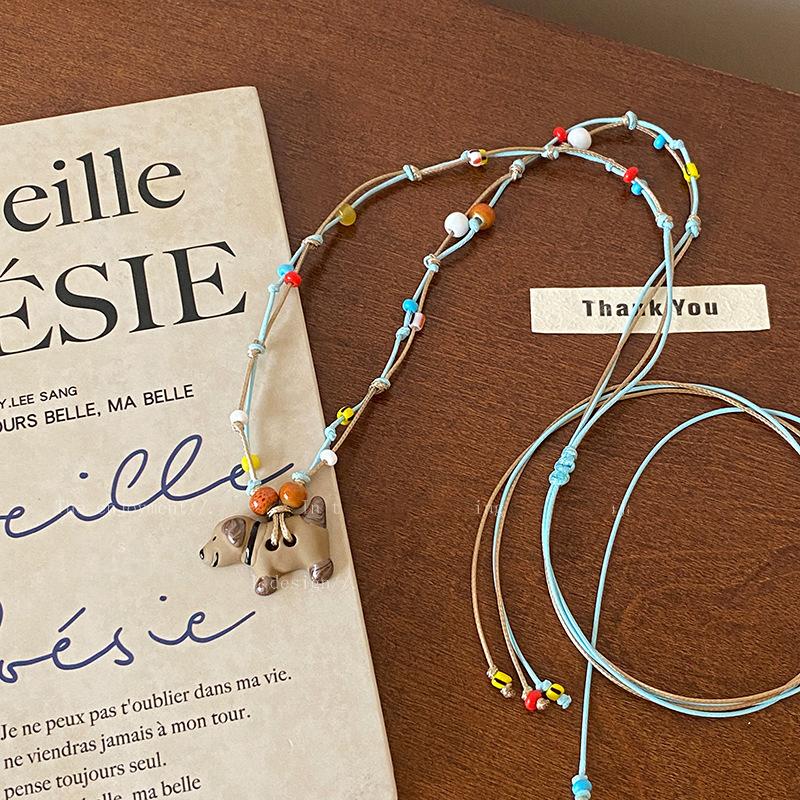 

Вощеная веревка, капающее масло, кулон-щенок, ожерелье, женское, милое, нишевая мода, универсальное длинное ожерелье, изысканные высококлассные аксессуары для волос