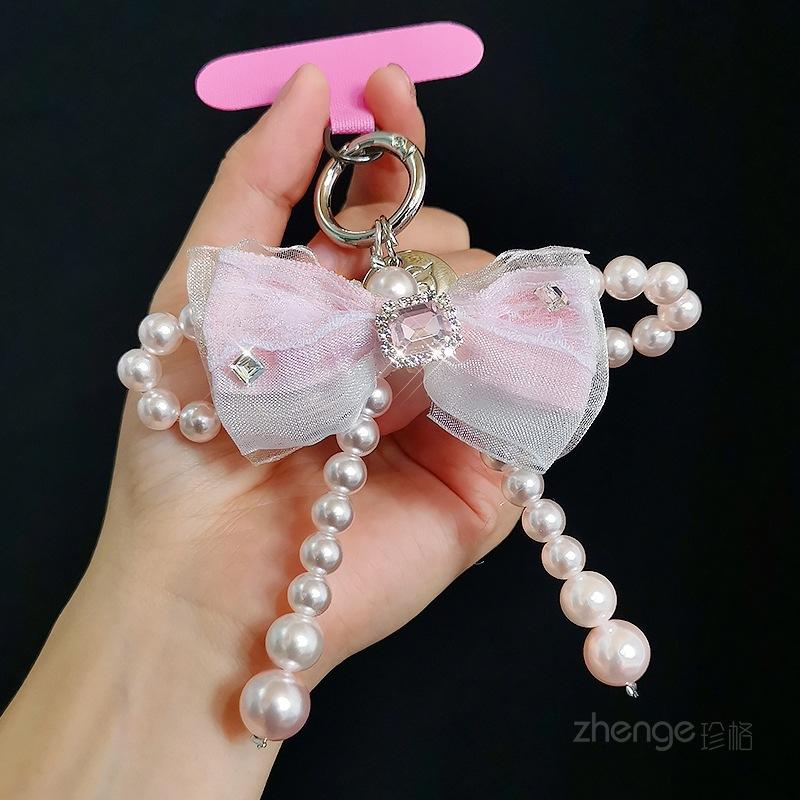 Mesh bow pearl bracelet women s ins fashion Xiaoxiangfeng mobile phone pendant mobile phone lanyard short wrist [pink] mesh bow pearl pendant + pink card strip