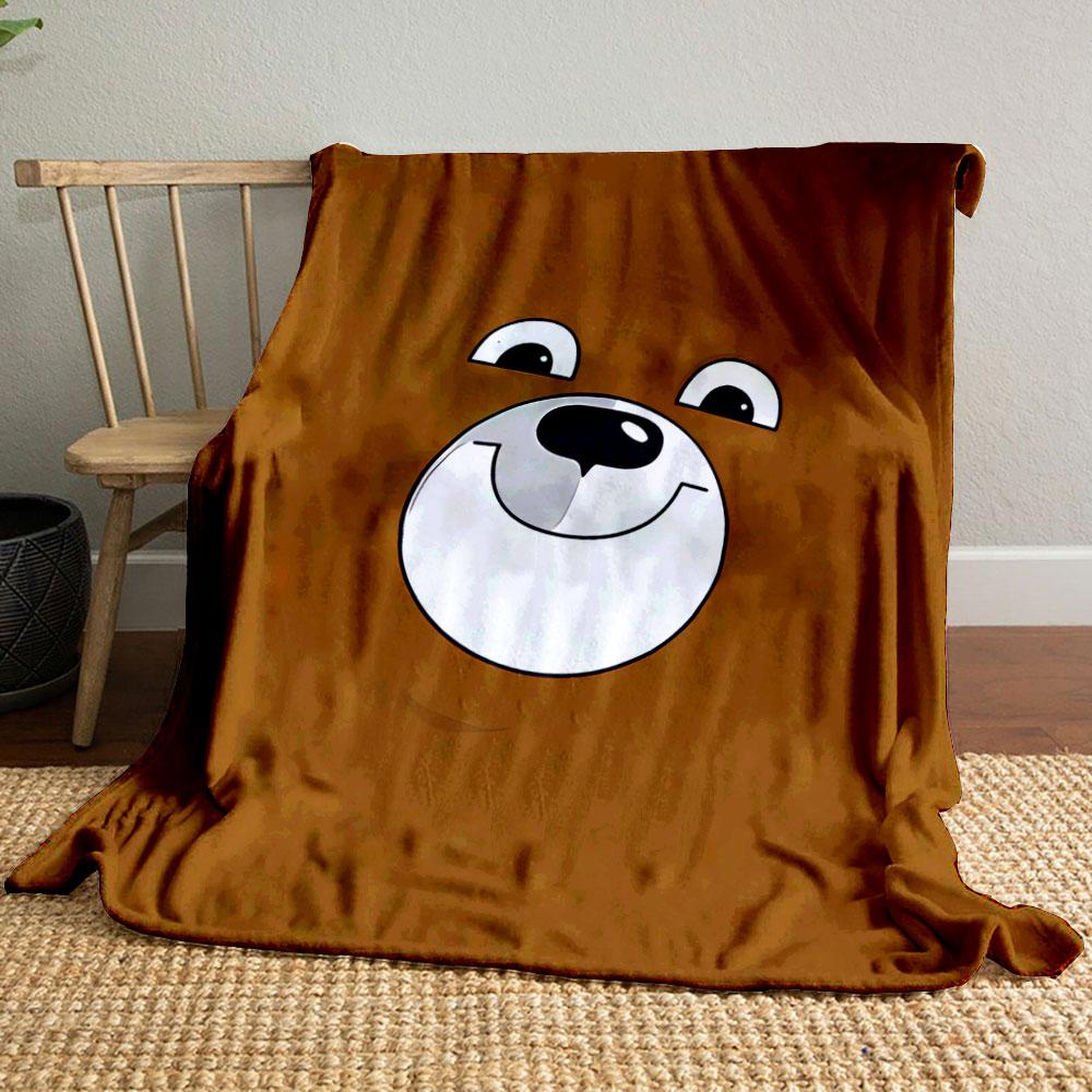 A smiling cartoon bear face on a brown background. for all seasons blanket lunch break throw gift