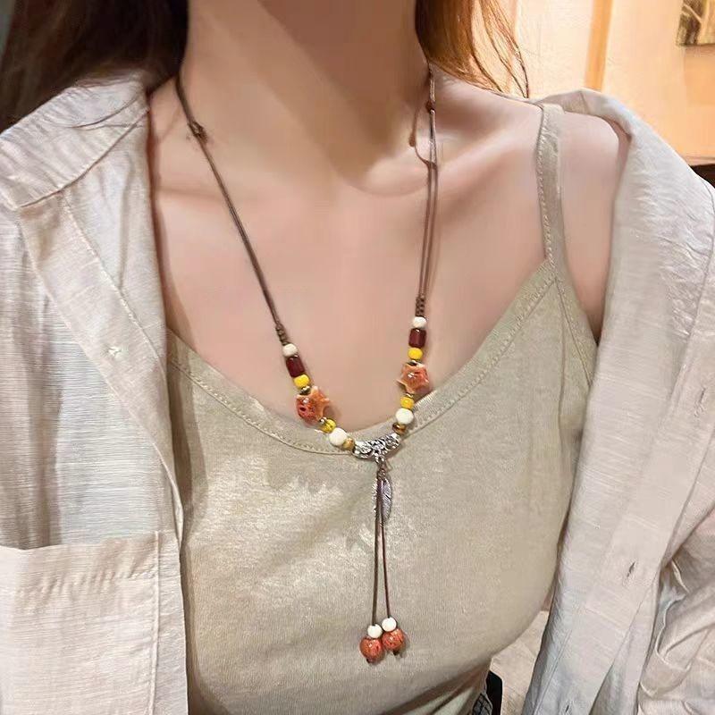 Retro pendant, ethnic style ceramic butterfly bell necklace, women's new trendy long sweater chain with accessories
