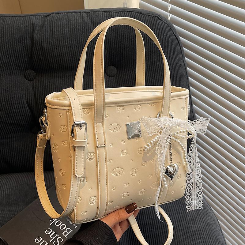 Spring and summer popular niche sweet and cute embossed portable bucket bag Korean version commuter casual versatile messenger bag bag woman
