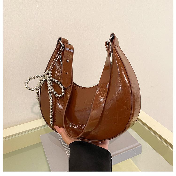

Fashion and popular semi-round underarm bag women s 2025 new spring fashion bow dumpling bag commuter shoulder bag темно-коричневого кольору