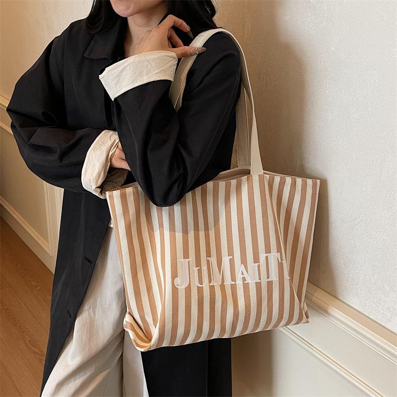 Niche design fashionable striped tote bag women's new large-capacity lazy wind shoulder bag canvas bag