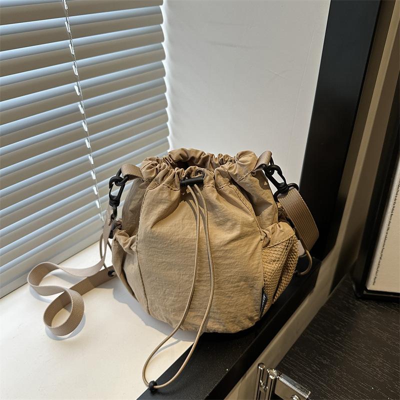 2025 Summer New Japanese and Korean Niche Drawstring Bundle Canvas Shoulder Messenger Bag Women's Light Lazy Wind Bucket Bag