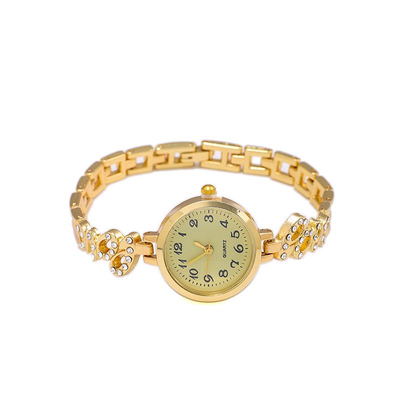 Nové dámské slitinové křemenné náramkové hodinky s náramkem s křídly z plných diamantů