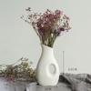 White Ceramic Vase with Dried Baby's Breath for Living Room or Dining Table Decoration