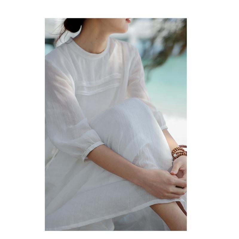 A Woman In A Double Layered Mid Length White Dress