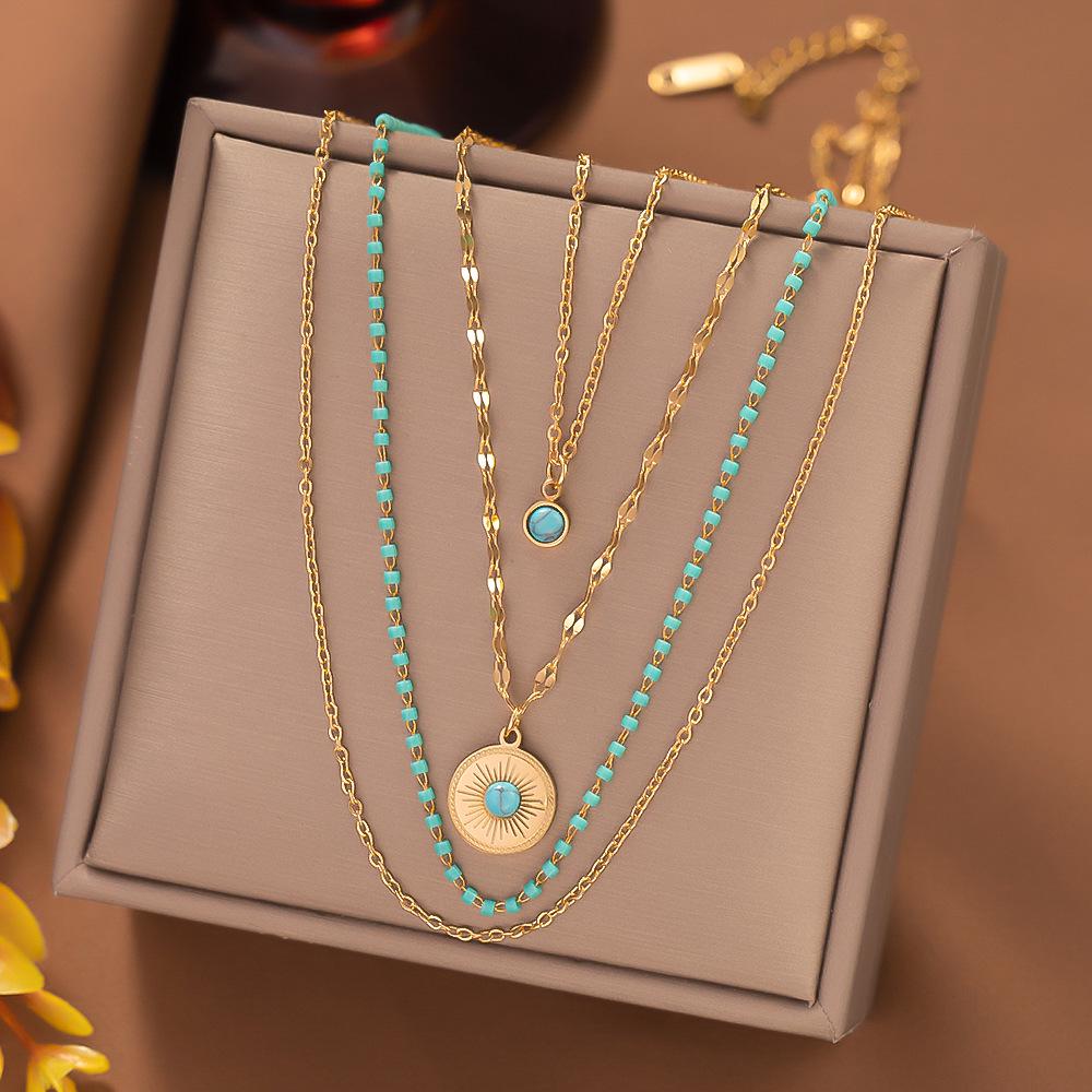 

Turquoise Titanium Steel Necklace: Four-Layer Chain with Irregular Round Tag Pendant