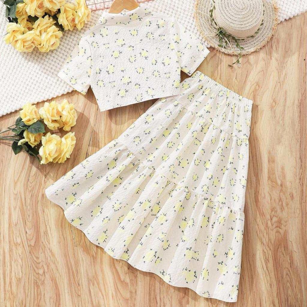 Flickors topp med blommigt slag och kjolset