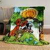 A cheerful sun and cartoon animals gather amid trees, grass, and flowers. for all seasons blanket lunch break throw gift