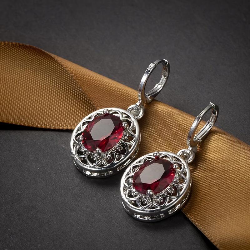A pair of hollow petal earrings inlaid with egg-shaped artificial crystals, a commemorative gift