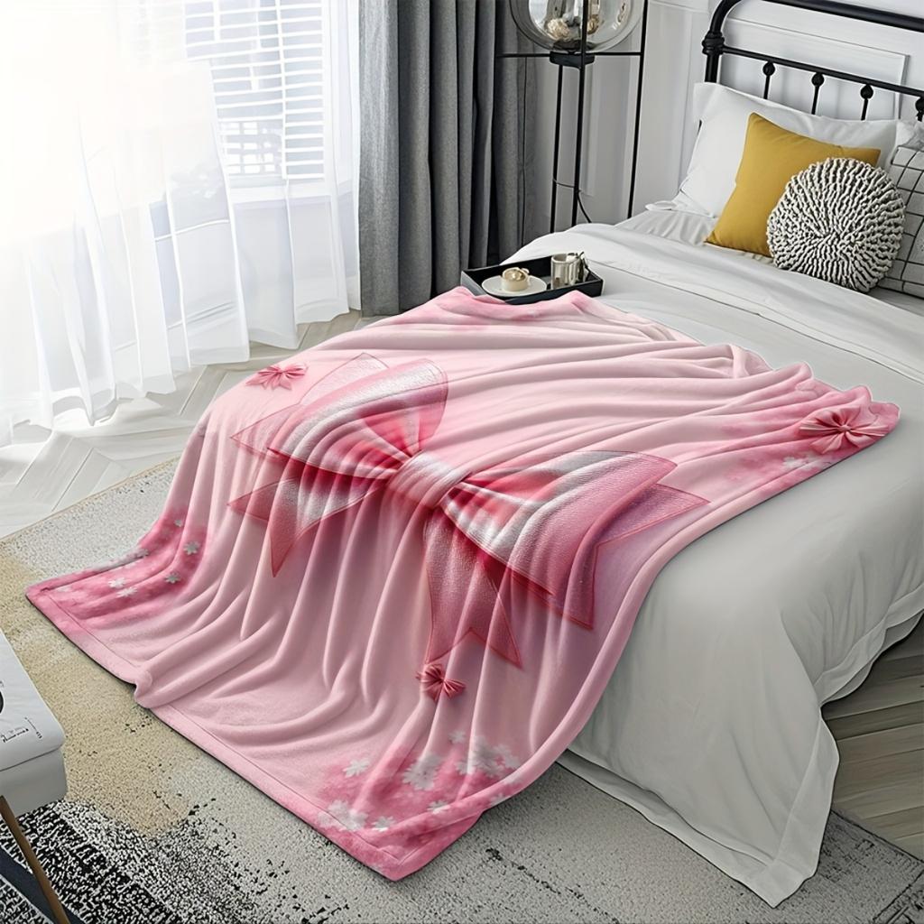 A Cozy Pink Flannel Blanket with a Bow Pattern - Soft and Warm, Perfect for Camping, Lounging On the Sofa, Bed, or Chair; a Grea