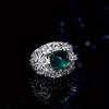 Luxurious geometric ring with bright green zircon and sparkling zirconia floral design in the center