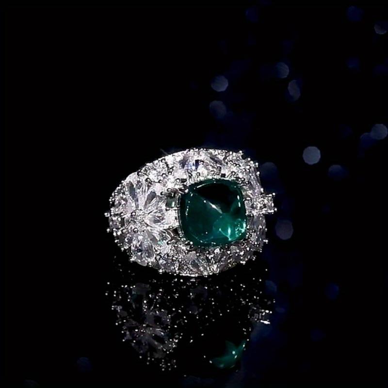 Luxurious geometric ring with bright green zircon and sparkling zirconia floral design in the center