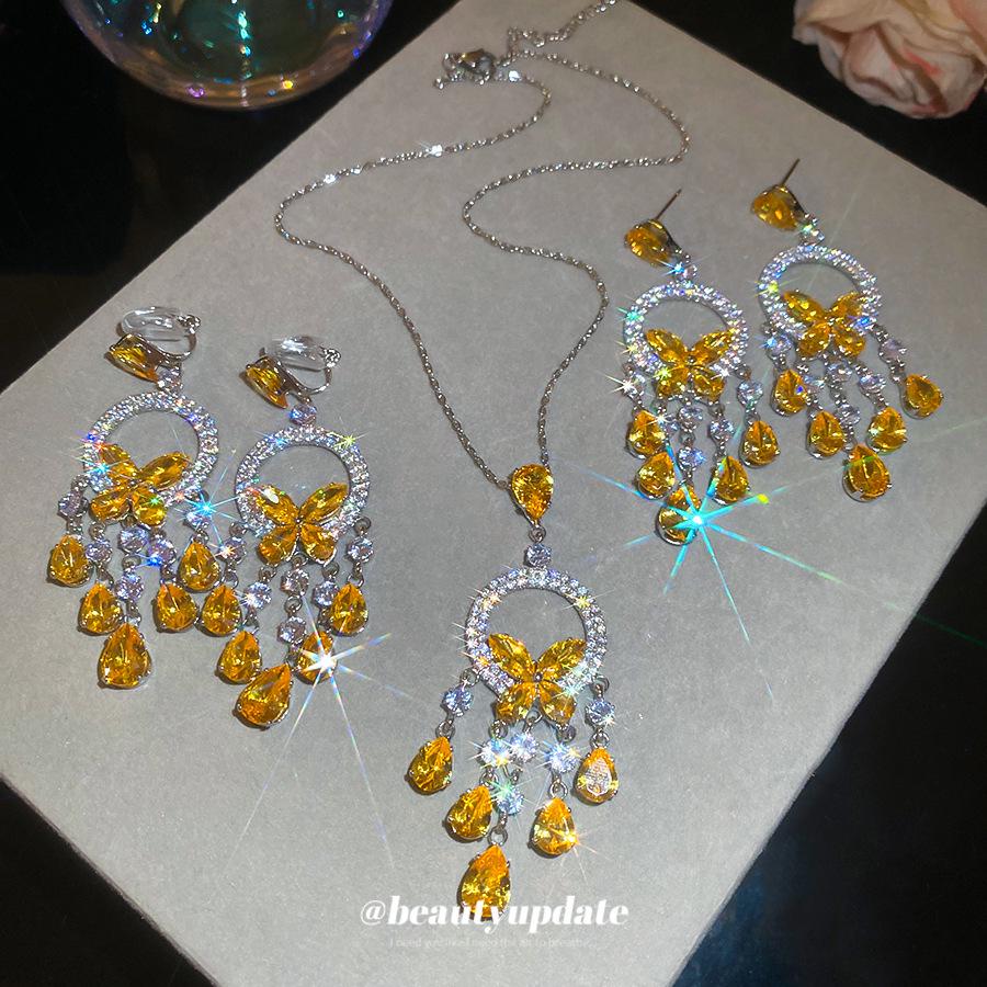 Silver Needle Diamond Inlaid Butterfly Tassel Earrings and Necklace Set: Elegant Hollow Design with Personality and Style.