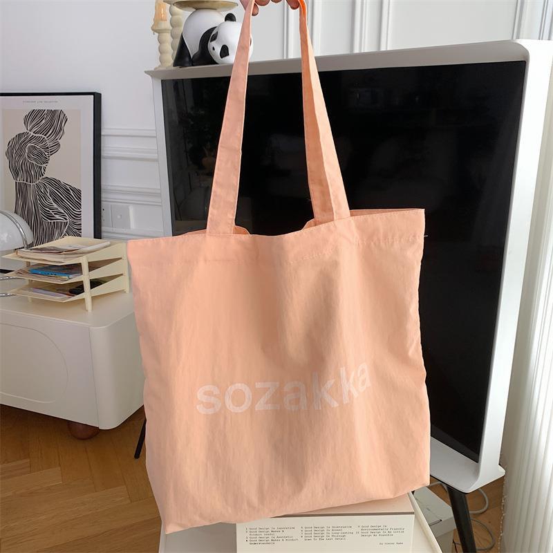 

New large-capacity canvas bag solid color shoulder bag simple printed letter tote bag shopping bag помаранчевий
