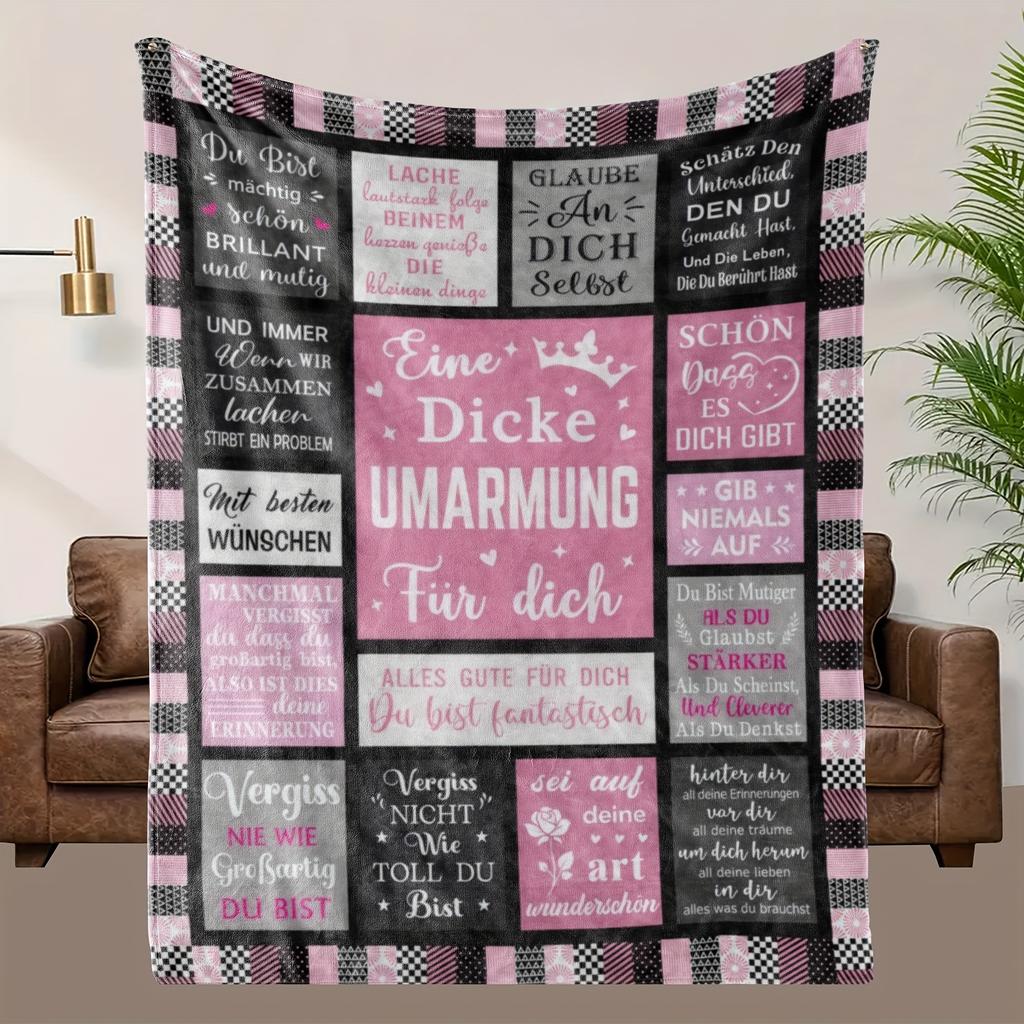 A Cozy German-Themed Graphic Fleece Blanket Made from Soft Fleece Material, Featuring Shades of Black, Gray, And Pink, Suitable for a Trendy