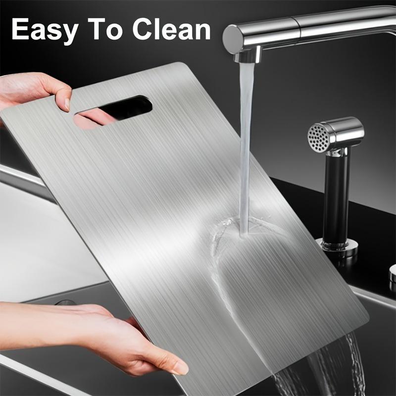 Premium double - sided titanium chopping board. Food - grade steel, durable, easy - clean, rustproof. Ergonomic handle, sleek look, great for kitchen.