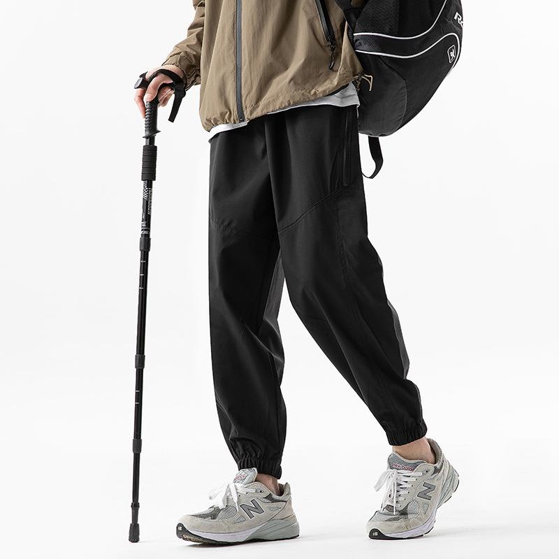 Functional waterproof charging pants spring and autumn loose tied feet casual breathable sports pants outdoor mountaineering trousers
