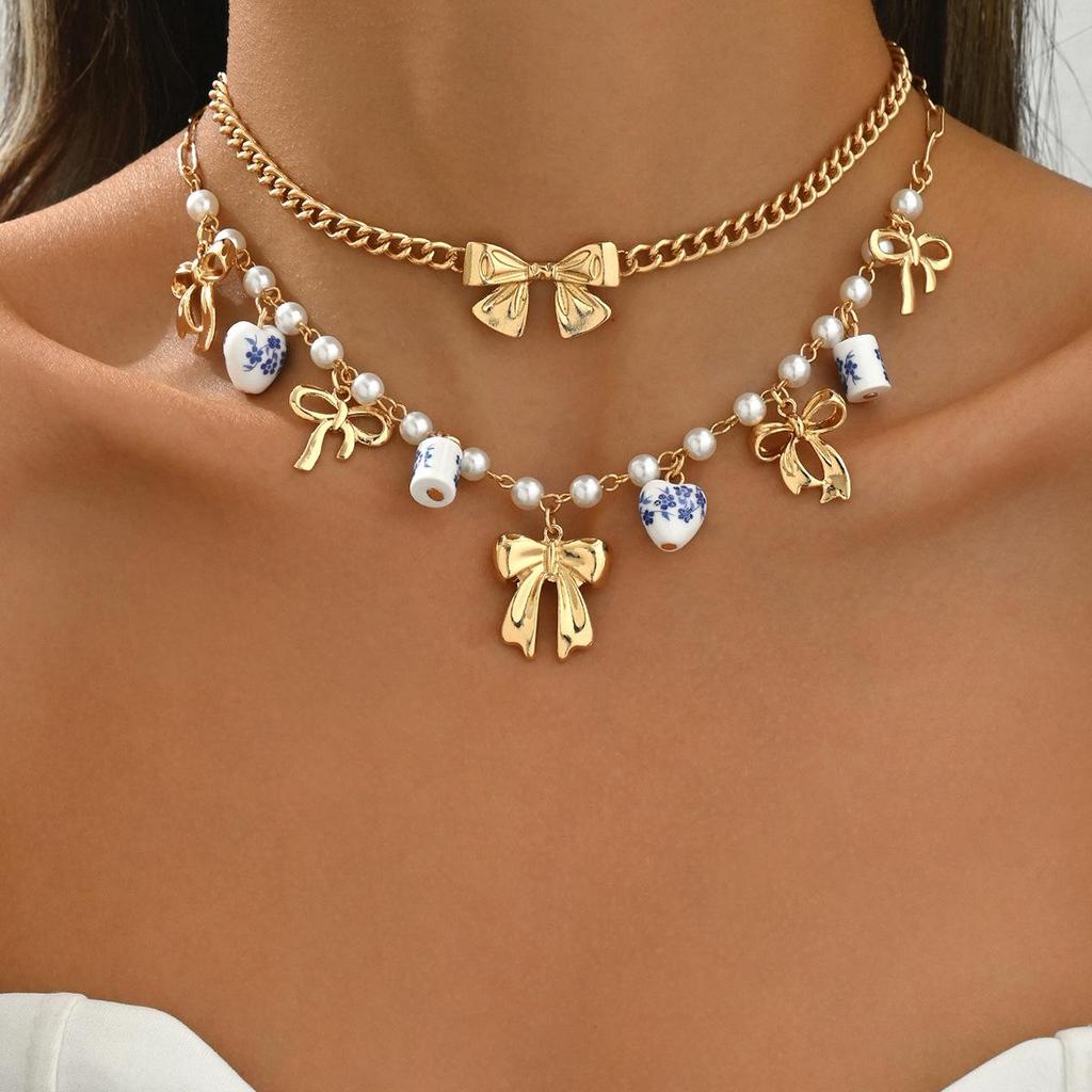 Doppellagige Perlen-Schleifen-Anhänger-Halskette - Modische Keramik-Schlüsselbeinkette