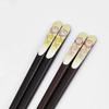 A pair of lacquered chopsticks for featuring a lucky charm design and a smiling owl presented in a paulownia wood Made in couples, motif, box. Japan.