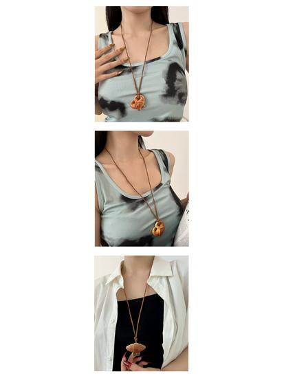 Women's Cute Knot Bread Pendant Necklace: Stylish Long Sweater Chain with Niche Design for a Fashionable Touch.